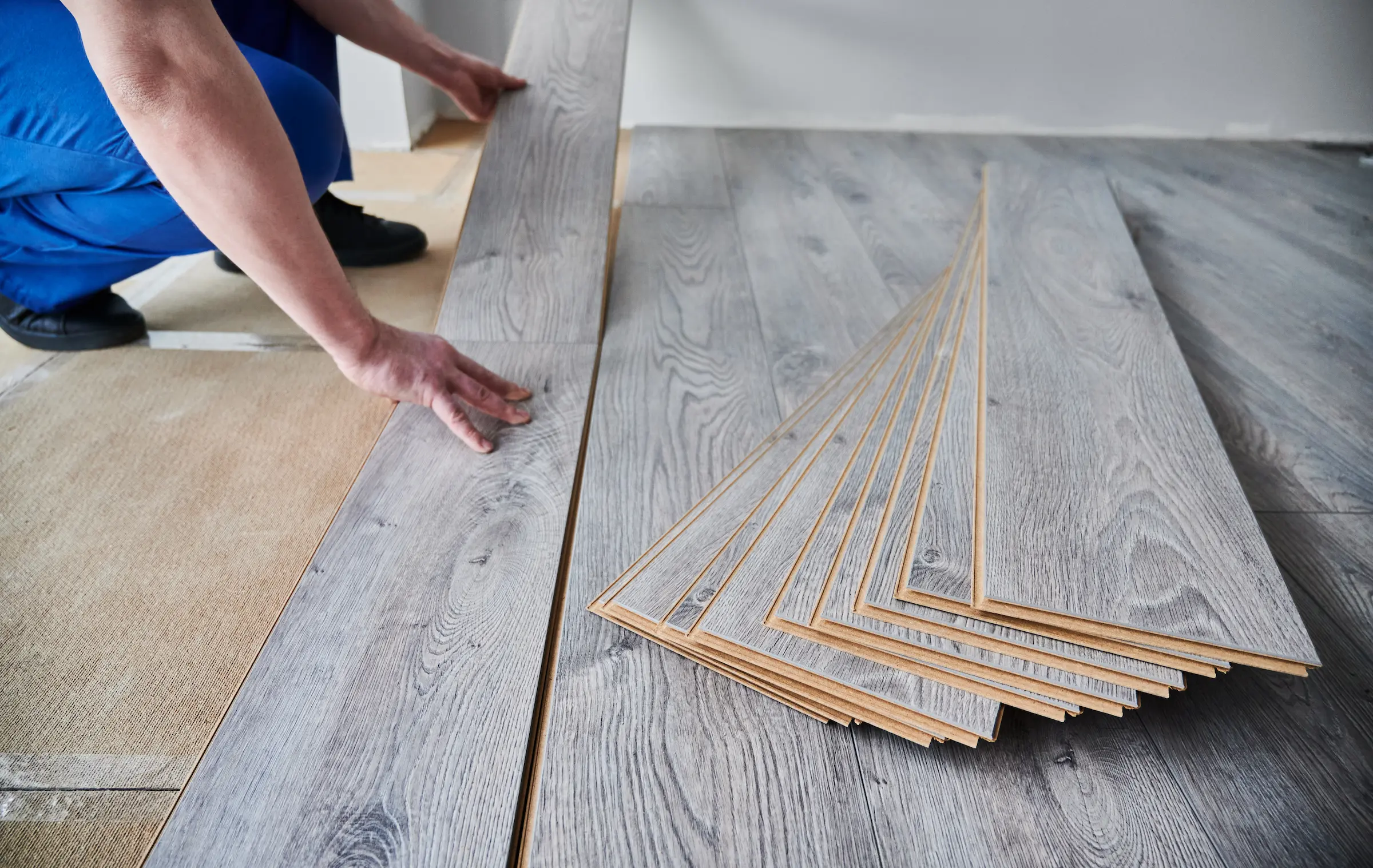 Laying grey laminate flooring in new home